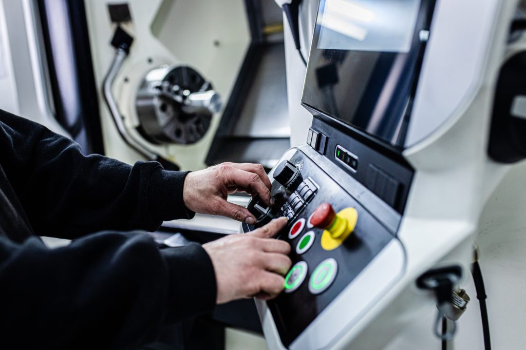 Close up man hand operating with CNC machine.